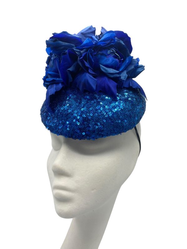 Stunning blue sequinned headpiece with handmade matching blue silk flower detail.